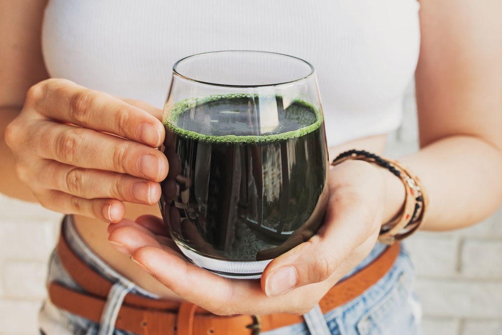 Woman,Holding,Glass,With,Healthy,Spirulina,Drink,Or,Green,Smoothie